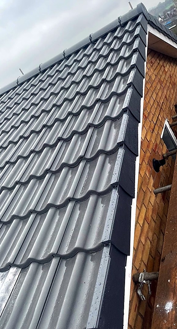New tiles and dry verge above a gable end