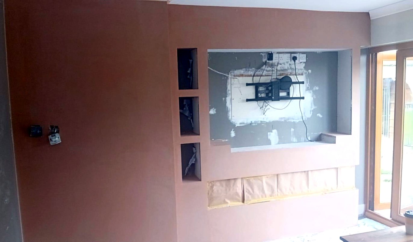 Media wall with three shelf niches and a TV recess